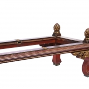 Carved wooden low table, polychrome in red and gold.