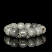 Bracelet with thirteen greyish jade beads, 20th century