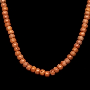 Bag with 180 coral-coloured beads, 20th century