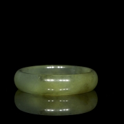 Circular carved jade bangle, 20th century