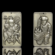 Pair of silver metal plaques, ‘Characters’, 20th century