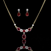 Conjunto de collar y pendientes en oro de 18k con rubíes y brillantes