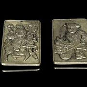 Pair of silver metal plaques, ‘Characters’, 20th century