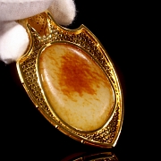 Gold-plated silver and Hetian jade pendant “Feline,” Qing dynasty