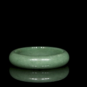 Rigid green jade bangle, 20th century