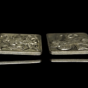 Pair of silver metal plaques, ‘Characters’, 20th century