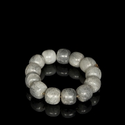 Bracelet with thirteen greyish jade beads, 20th century