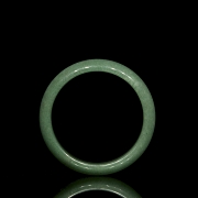 Rigid green jade bangle, 20th century