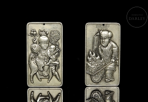 Pair of silver metal plaques, ‘Characters’, 20th century