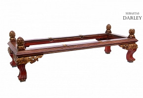 Carved wooden low table, polychrome in red and gold.