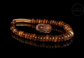 Set comprising a necklace and carved antler figure, 20th century