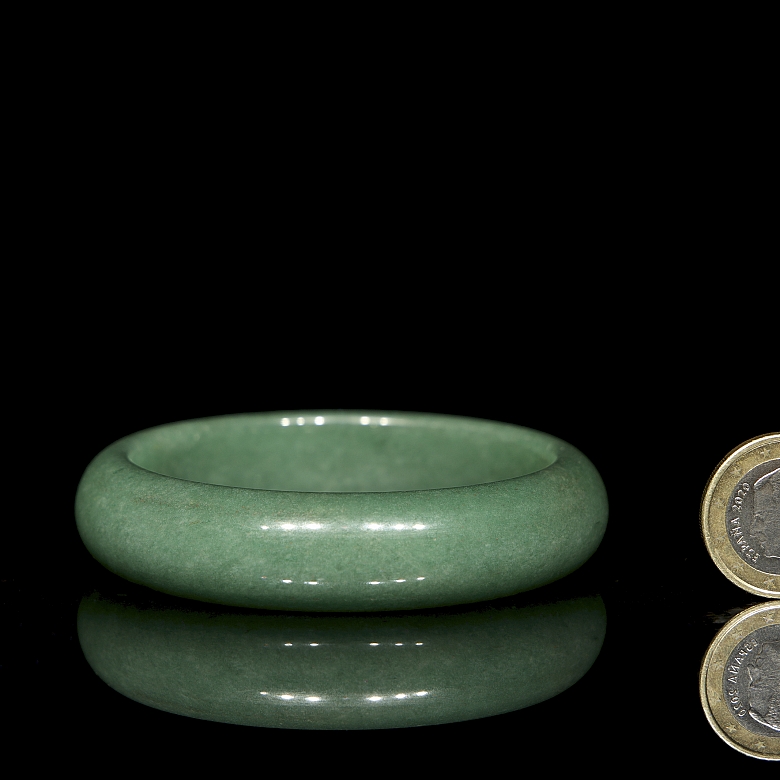 Rigid green jade bangle, 20th century