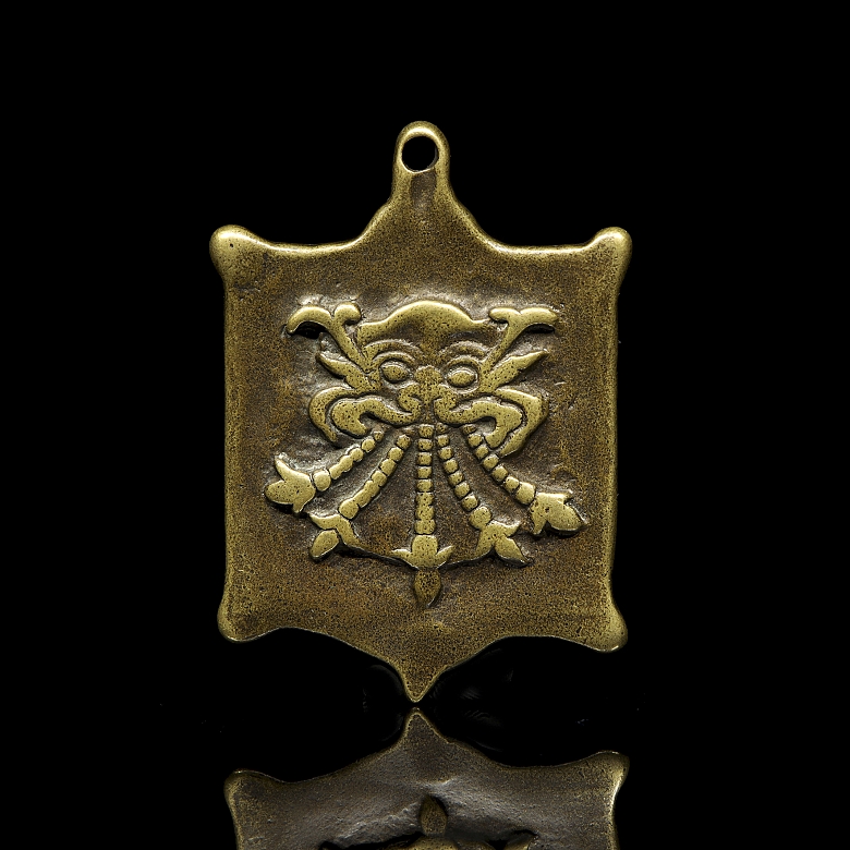 Amuleto de bronce