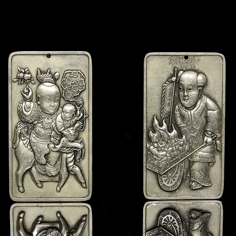 Pair of silver metal plaques, ‘Characters’, 20th century