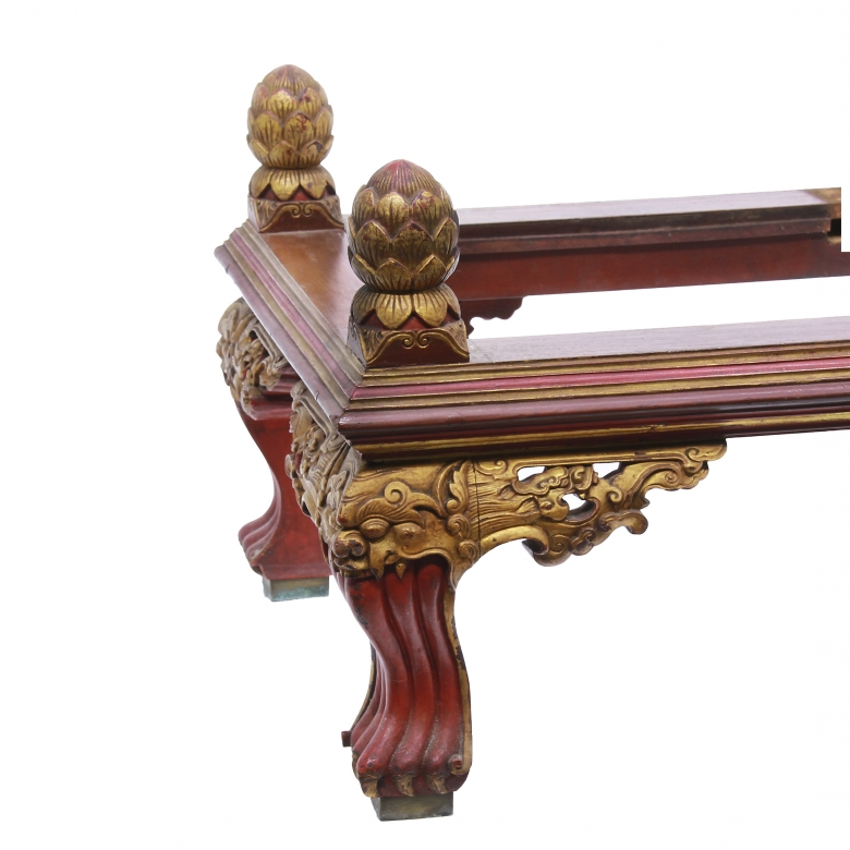 Carved wooden low table, polychrome in red and gold.