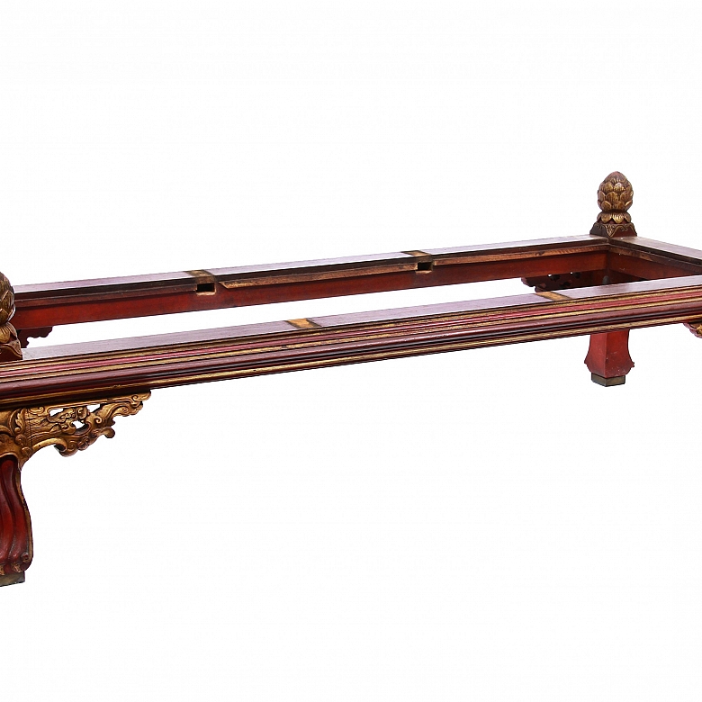 Carved wooden low table, polychrome in red and gold.