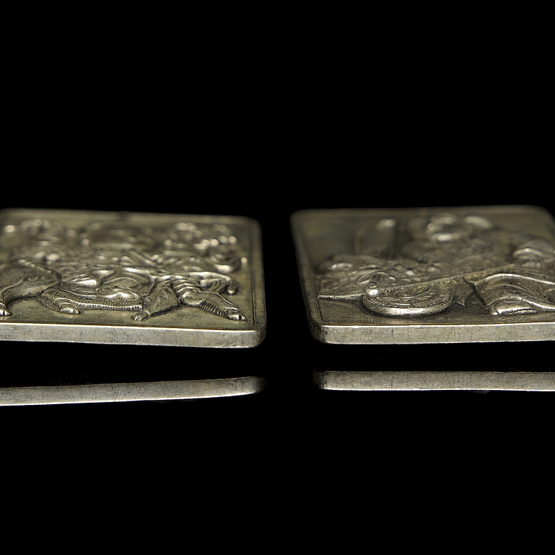 Pair of silver metal plaques, ‘Characters’, 20th century